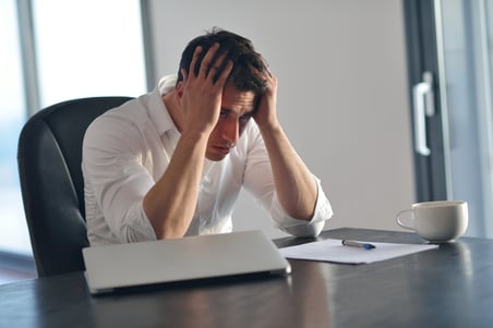 frustrated with problems young business man working on laptop computer at home